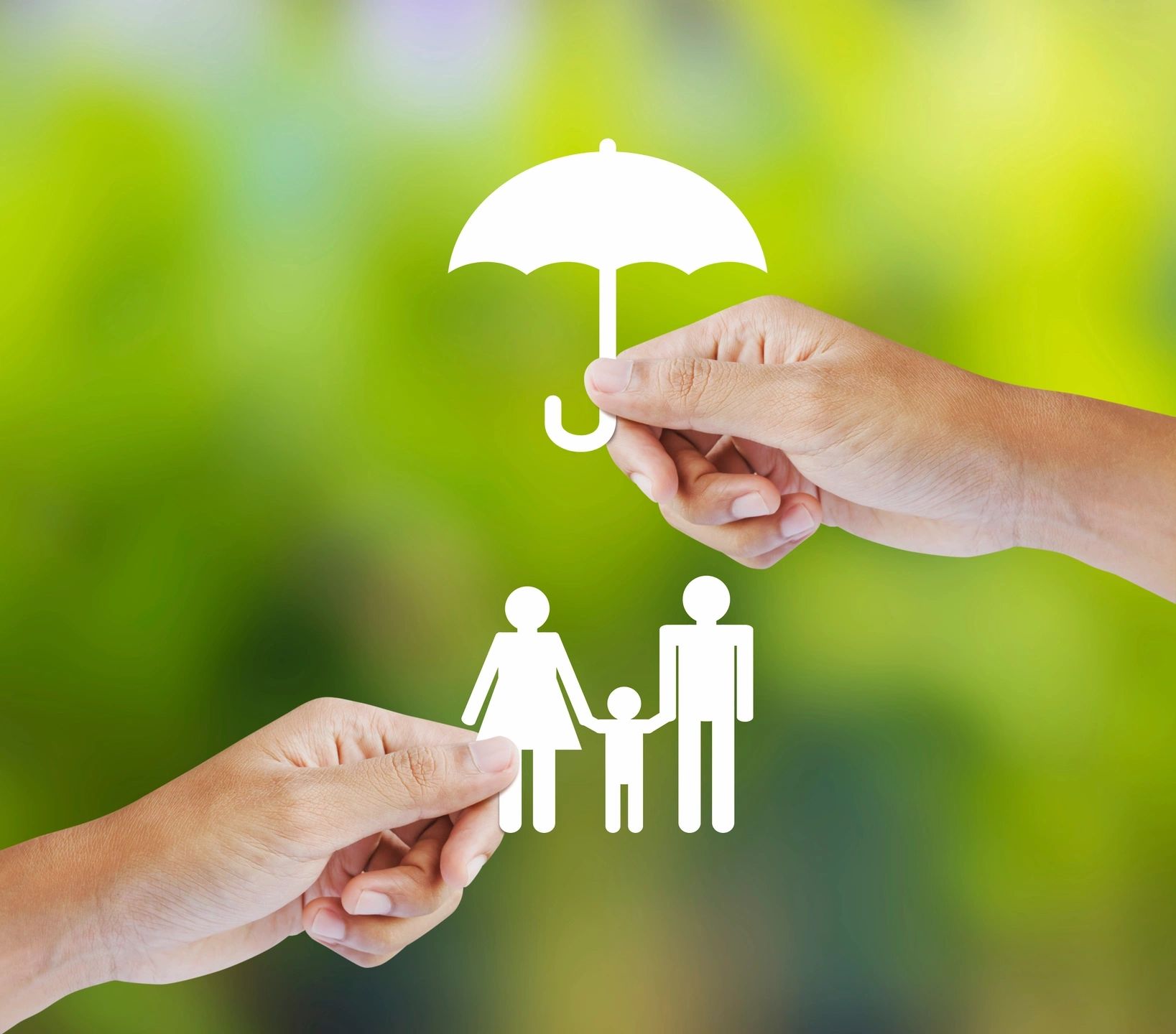 Hands holding paper cutouts of a family and umbrella symbolizing protection.
