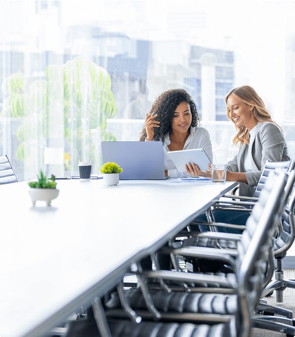 Two women collaborating in modern office setting.