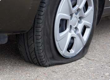 Flat car tire on road